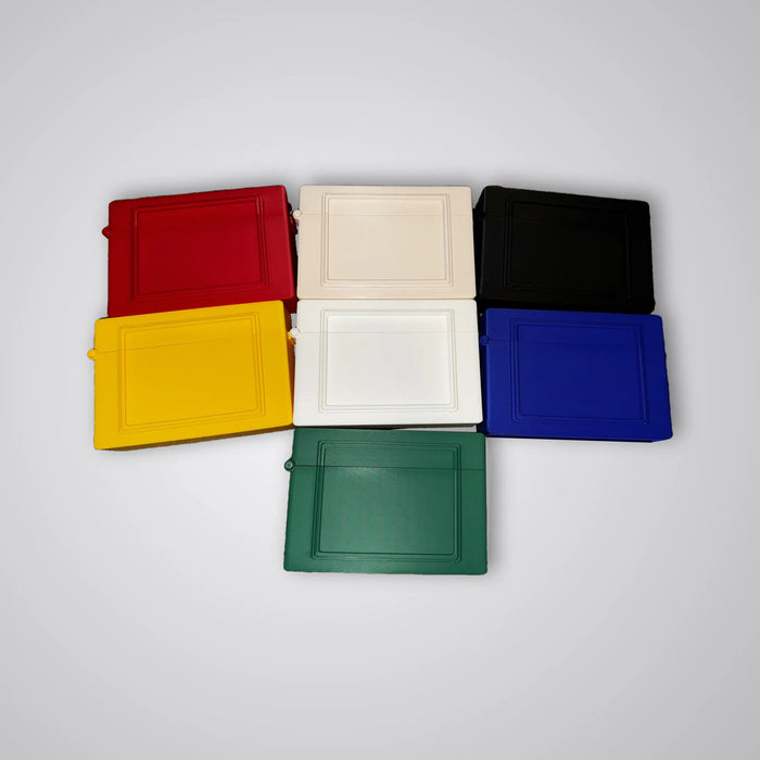 Commander deck box shown in all seven available colors: red, beige, black, yellow, white, blue, and green