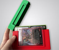 Two Commander deck boxes, red and green, open side by side showing sleeved Magic: The Gathering cards